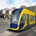 A computer-generated mock up of a G:link tram crossing the intersection of Nerang St and High St with the old Gold Coast Hospital building in the background